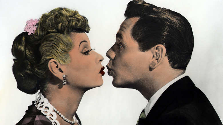 Lucille Ball and Desi Arnaz posing for a kiss