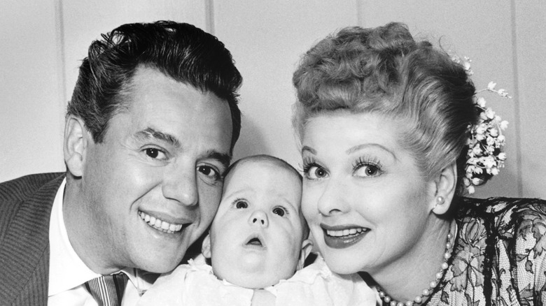 Lucille Ball and Desi Arnaz pose with their child