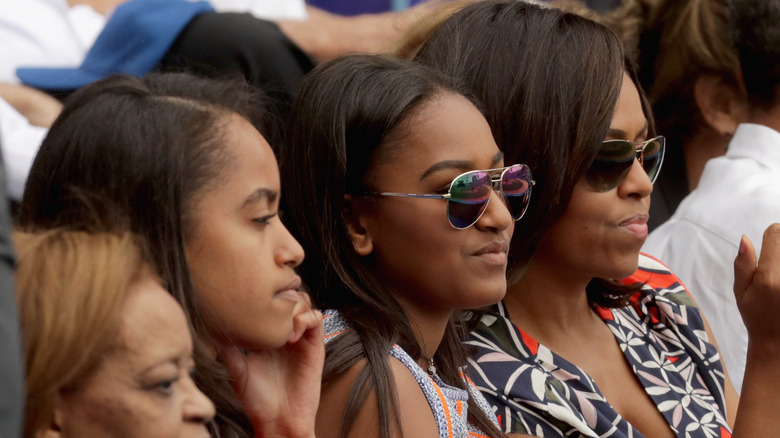 Malia and Sasha sit with Michelle Obama