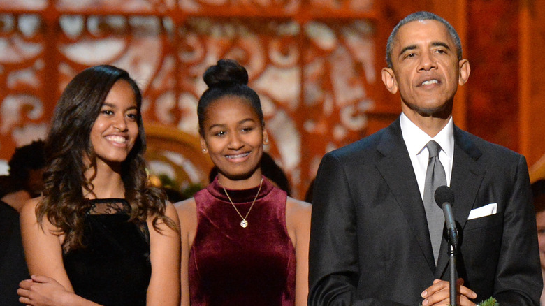 Malia and Sasha watch as Barack Obama speaks