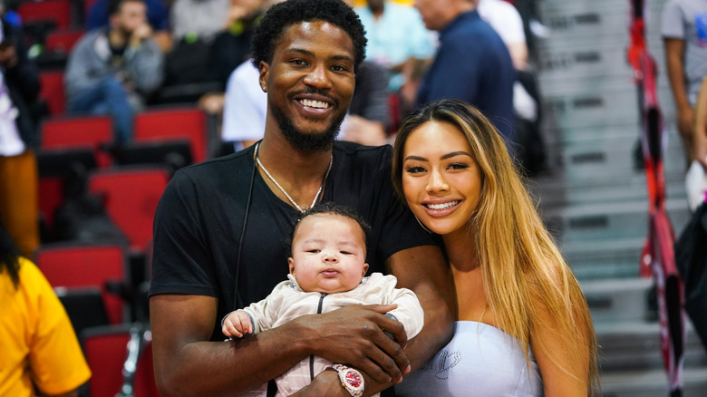 Malik Beasley and Montana Yao posing with their son