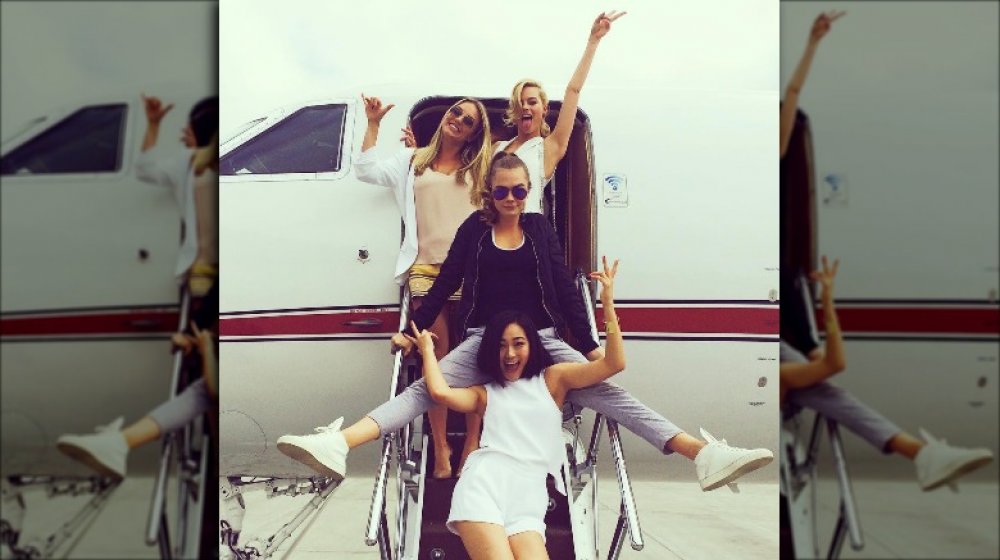 Margot Robbie, Sophia Kerr, Cara Delevingne, Karen Fukuhara posing outside a private jet