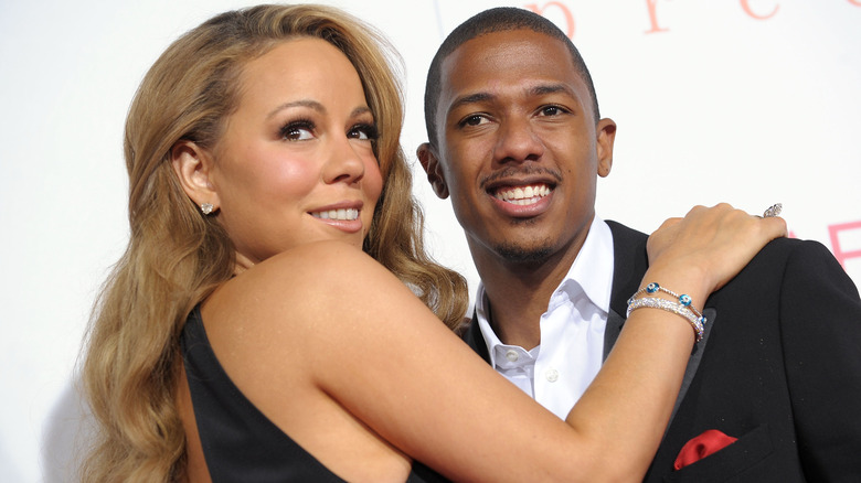 Mariah Carey grips Nick Cannon as both smile