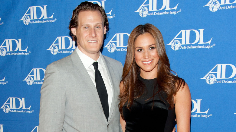 Trevor Engelson and Meghan Markle posing