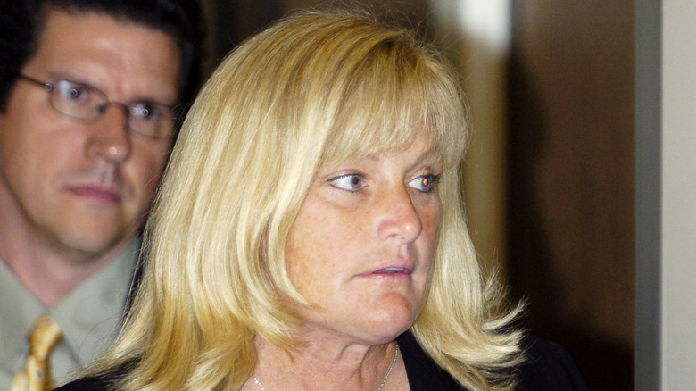 Debbie Rowe looking off to the side