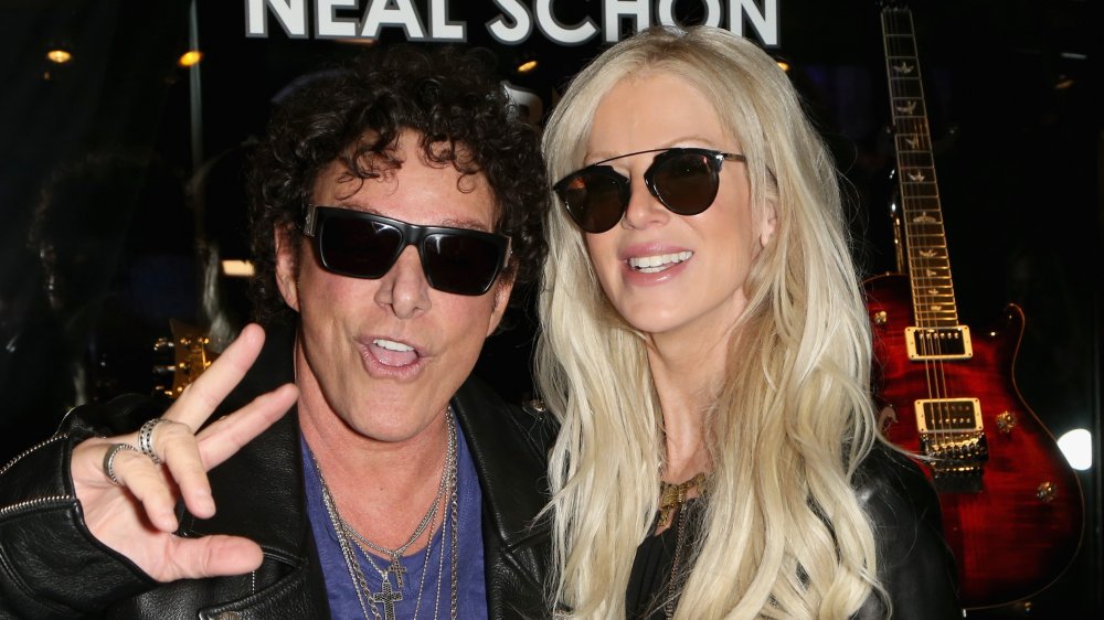 Neal Schon and Michaele Salahi (Schon) posing together at a music event