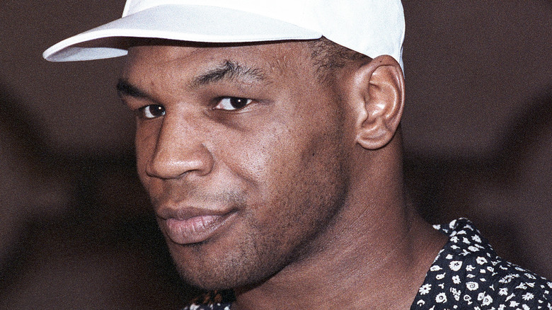 Mike Tyson wearing white baseball cap