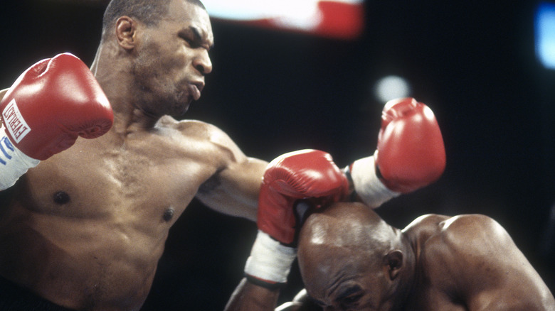 Mike Tyson red boxing gloves hitting Evander Holyfield