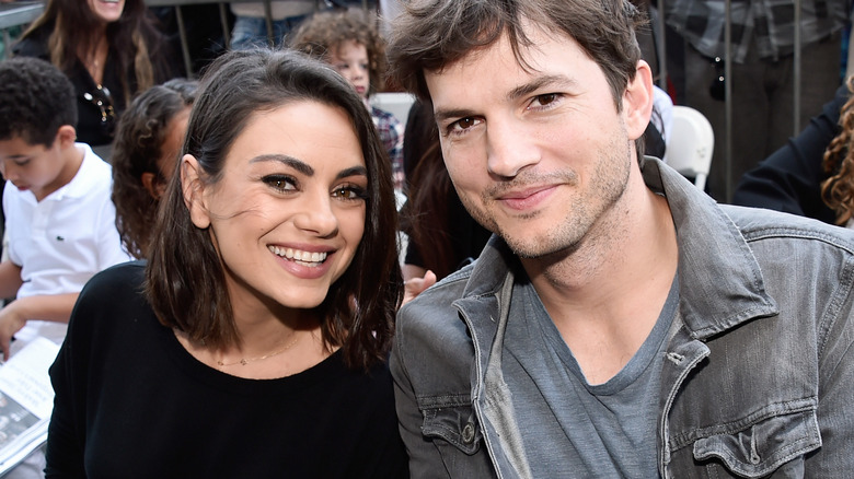 Mila Kunis smiles alongside Ashton Kutcher