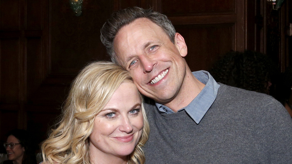 Seth Meyers hugging Amy Poehler 