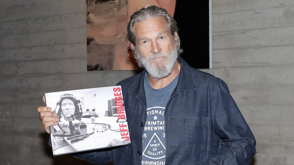 Jeff Bridges holding book of photography