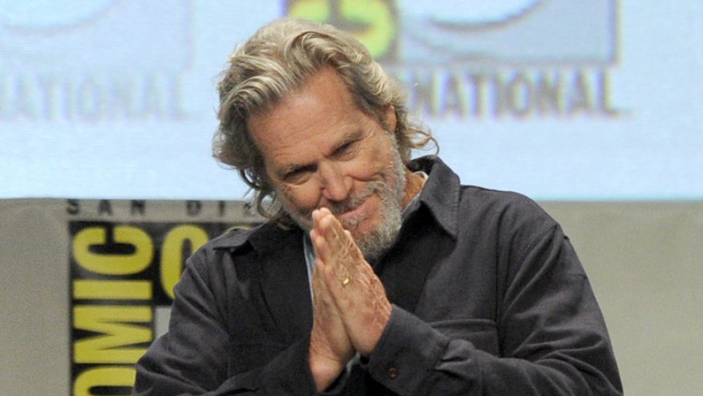 Jeff Bridges with hands clasped in prayer