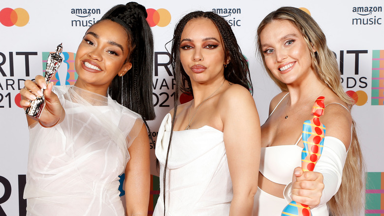 Little Mix posing with their BRIT Awards