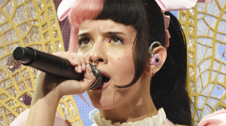 Melanie Martinez singing into a mic 