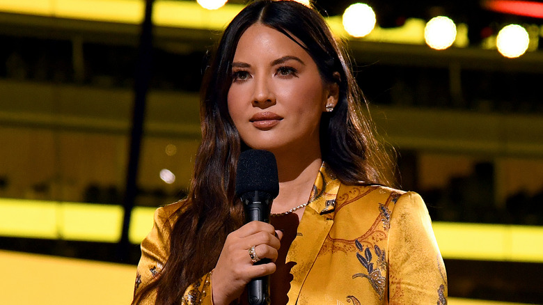 Olivia Munn holding microphone