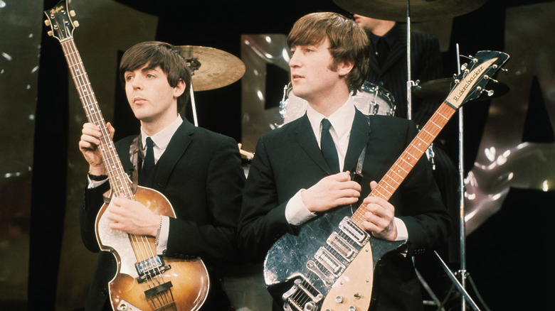 Paul McCartney and John Lennon with their guitars.