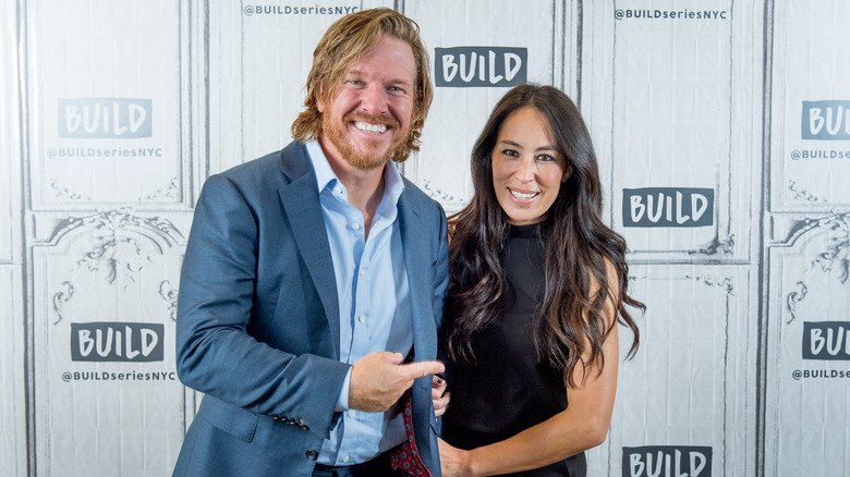 Chip Gaines pointing at Joanna Gaines