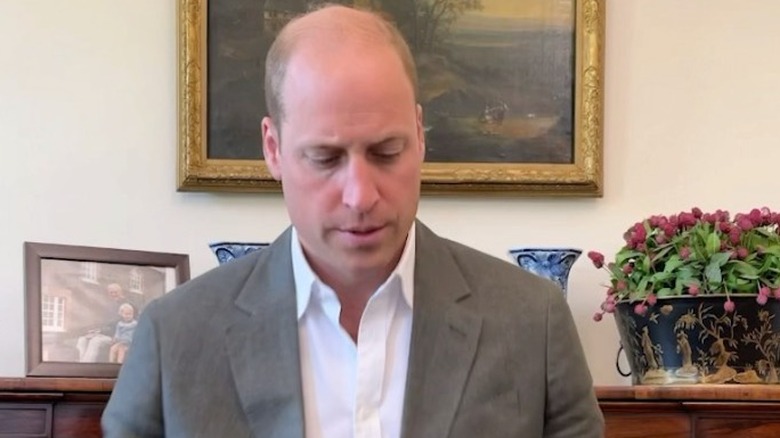 Prince William sitting at his desk