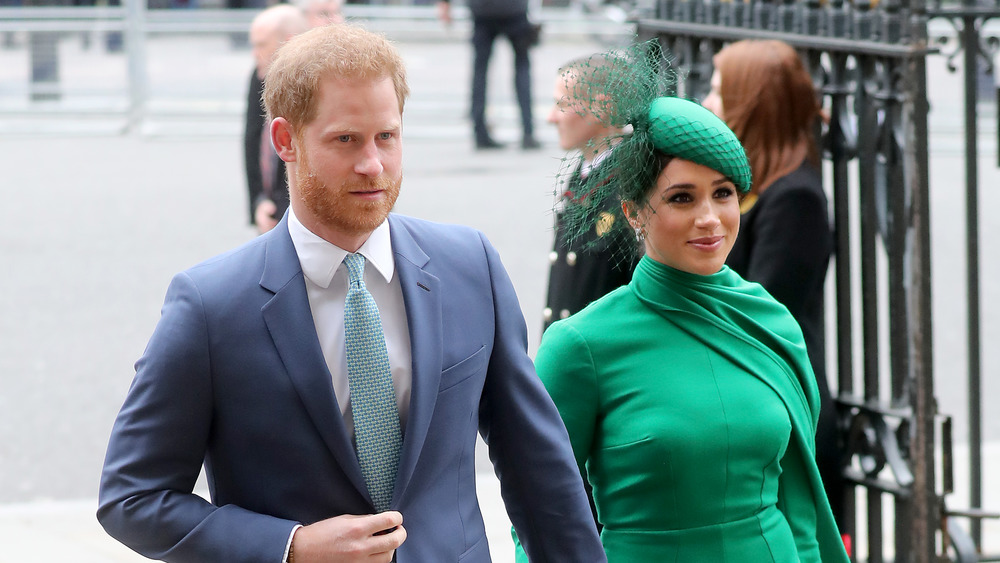 Prince Harry and Meghan Markle walk together during a public appearance