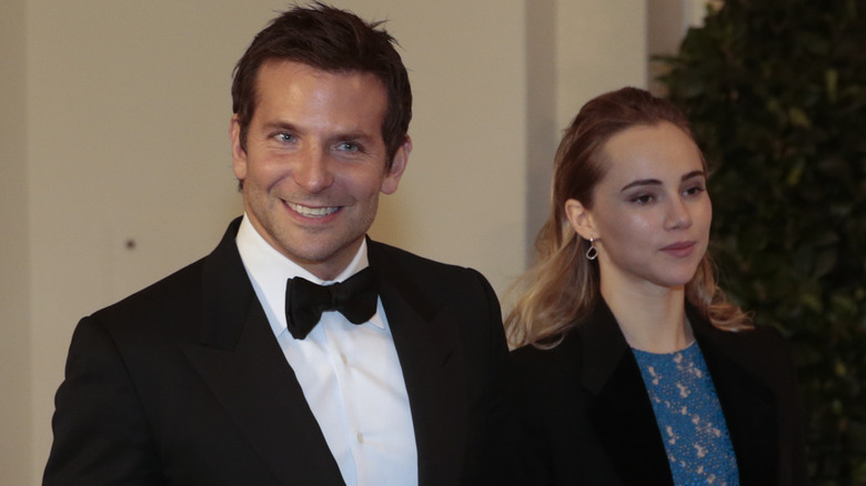 Bradley Cooper holding hands with Suki Waterhouse