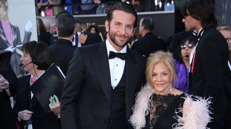 Bradley Cooper and his mother posing for a picture