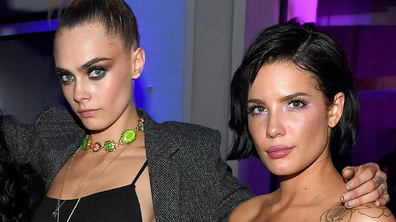 Cara Delevingne black eyeshadow holds Halsey black hair