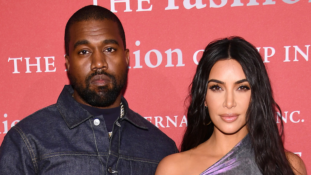 Kanye West and Kim Kardashian posing together on the red carpet