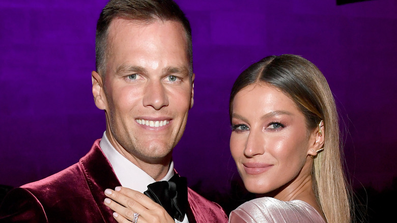 Gisele Bündchen smiling hand on Tom Brady velvet jacket