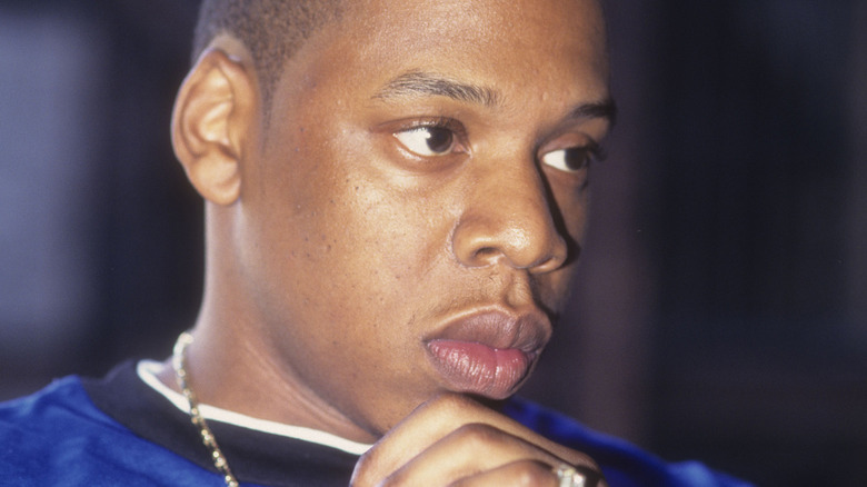 Jay-Z poses in a blue shirt in 1996