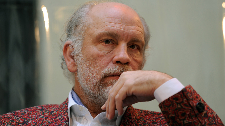 John Malkovich rests head on his hand