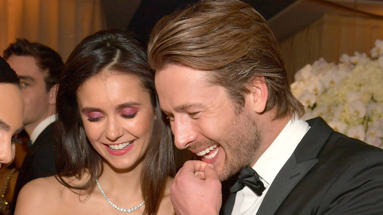 Nina Dobrev and Glen Powell laughing