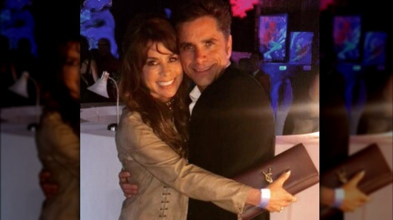 Paula Abdul hugging John Stamos