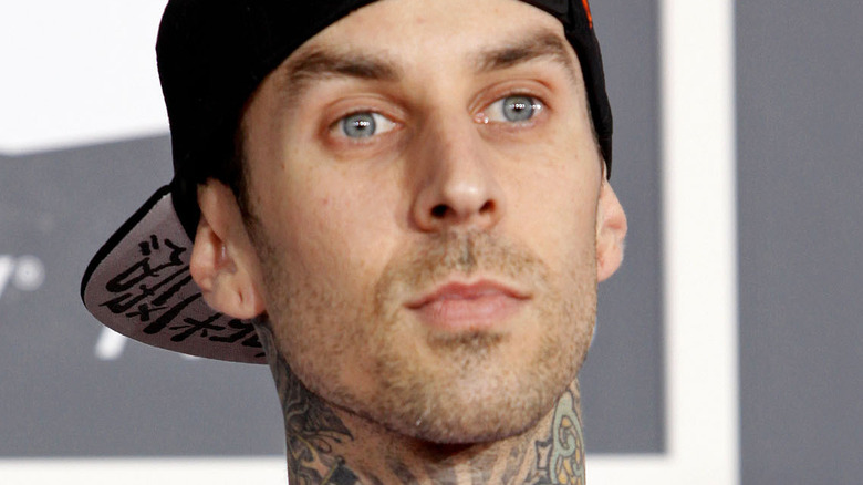 Travis Barker wearing a black baseball cap