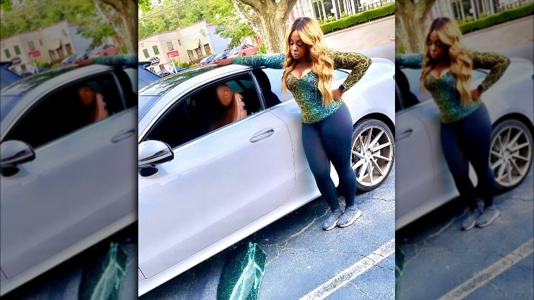 Phaedra Parks, standing next to her car that was broken into, looking upset