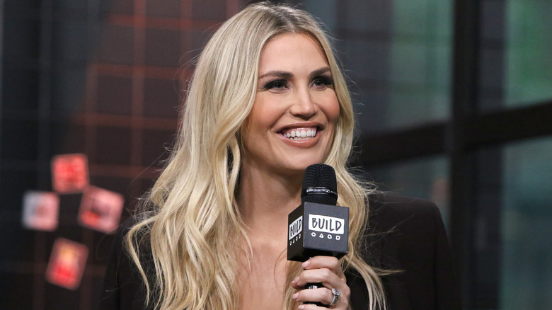 Willa Ford smiling, holding microphone