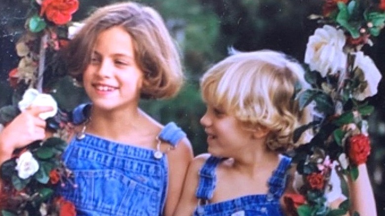 Riley Keough and Benjamin Keough little kids on swing