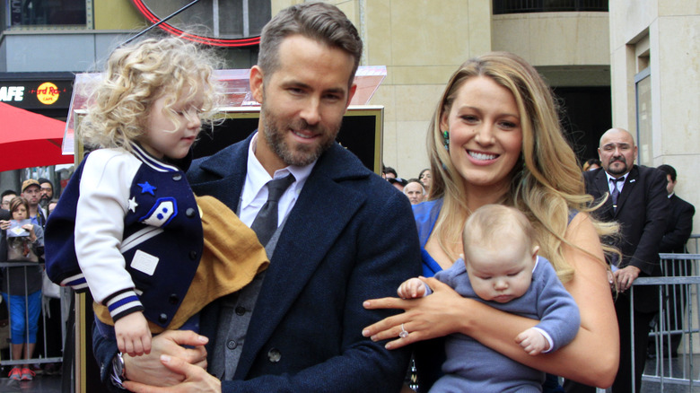 Ryan Reynolds and Blake Lively posing with their daughters