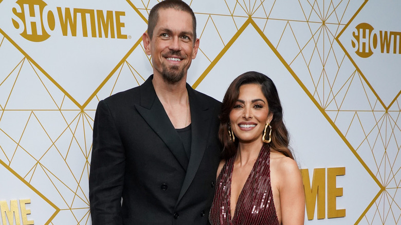 Sarah Shahi and Steve Howey posing