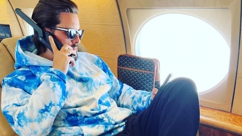 Scott Disick using satellite phone on airplane