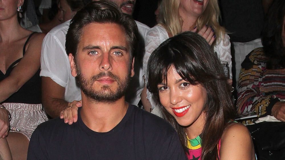 Scott Disick and Kourtney Kardashian posing with her arm around his shoulder