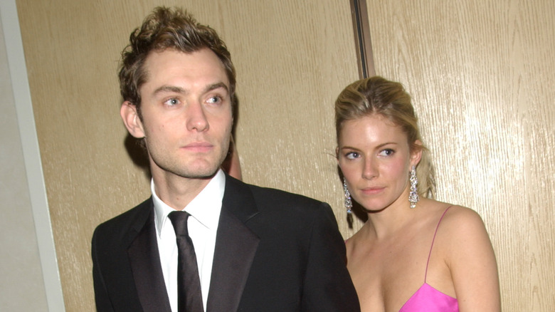 Sienna Miller behind Jude Law 