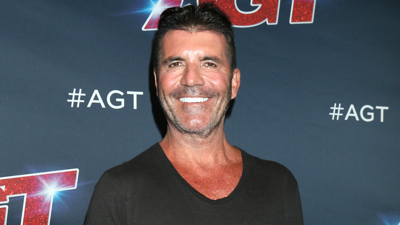 Simon Cowell smiles at an "America's Got Talent" event