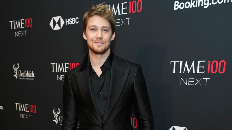 Joe Alwyn poses in black