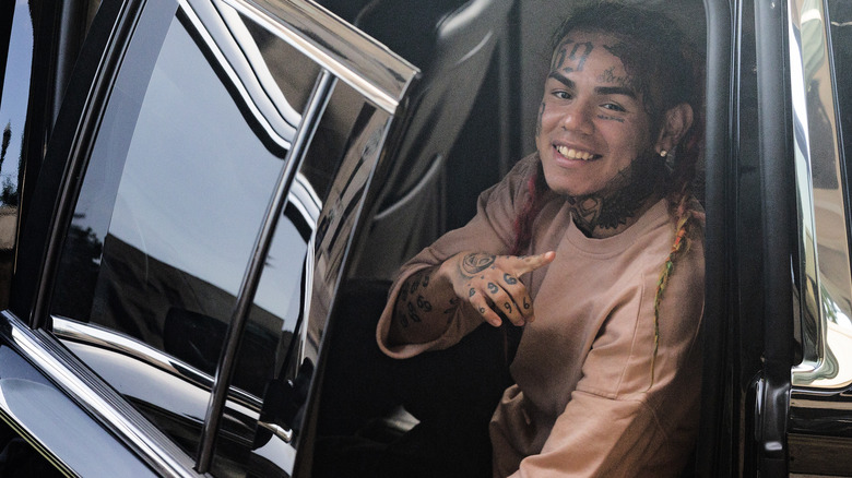 Tekashi 6ix9ine posing in SUV