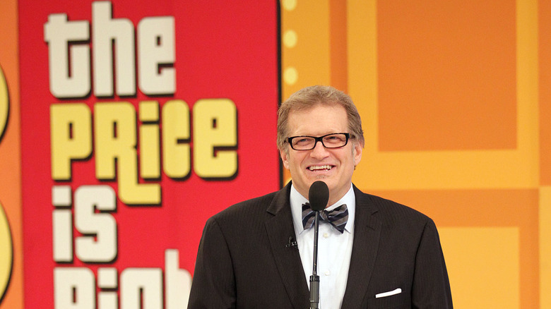 Drew Carey in front of microphone, smiling