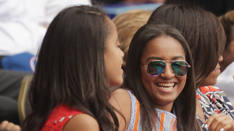 Sasha Obama laughs with Malia