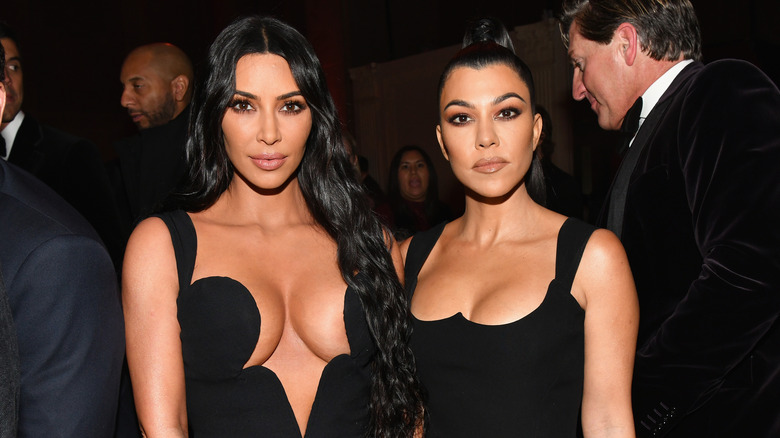 Kim and Kourtney Kardashian at an event 