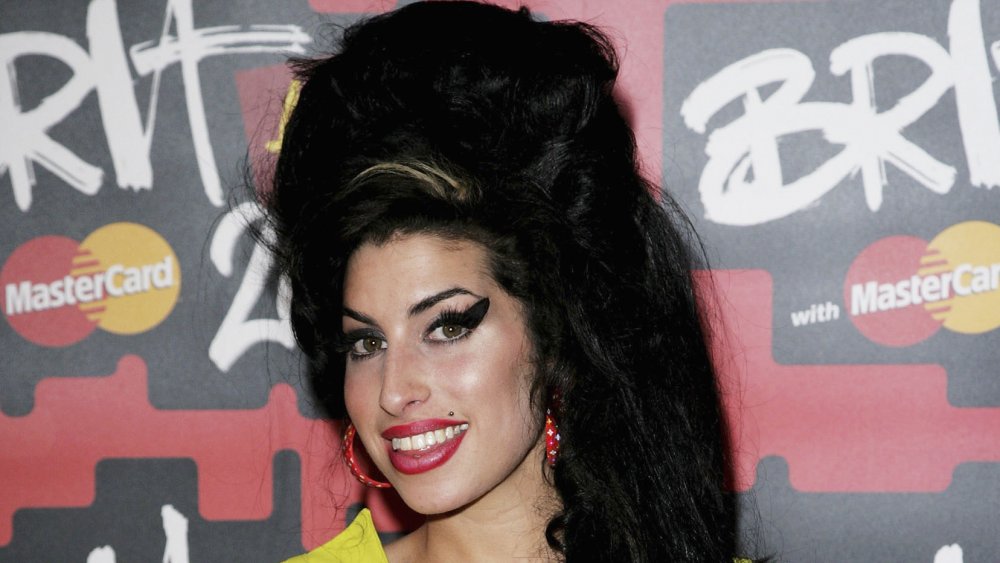 Amy Winehouse with her signature beehive hair and exaggerated eyeliner 