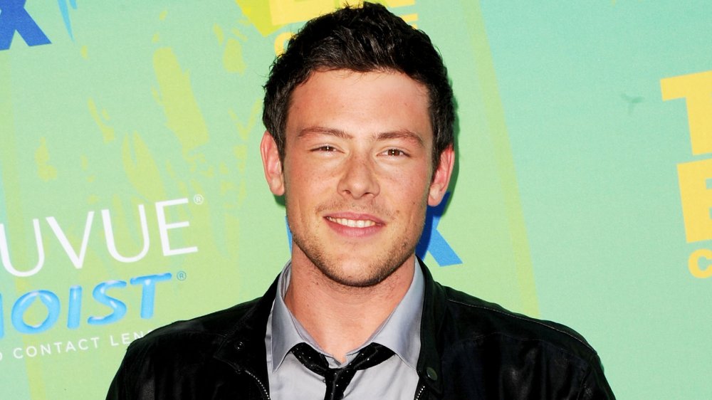 Cory Monteith in a leather jacket, smiling