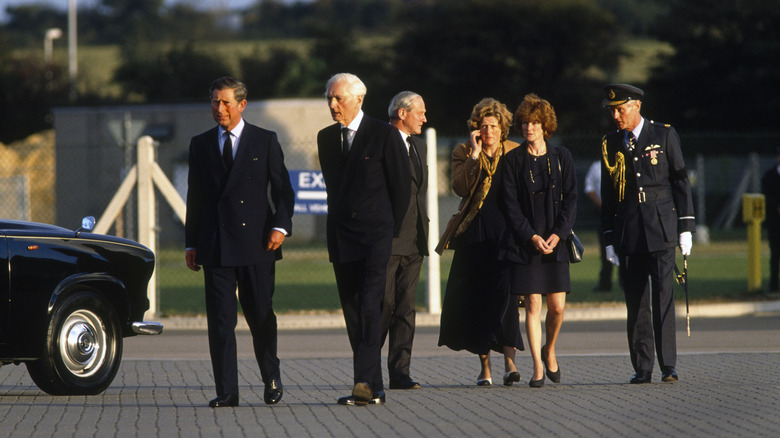 Prince Charles, Lady Sarah McCorquiodale and her sister Lady Jane Fellows being photographed at RAF Northolt Airport